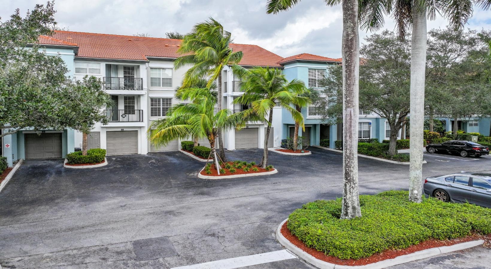 Find your perfect fit at The Sophia at Abacoa a building with palm trees and a parking lot