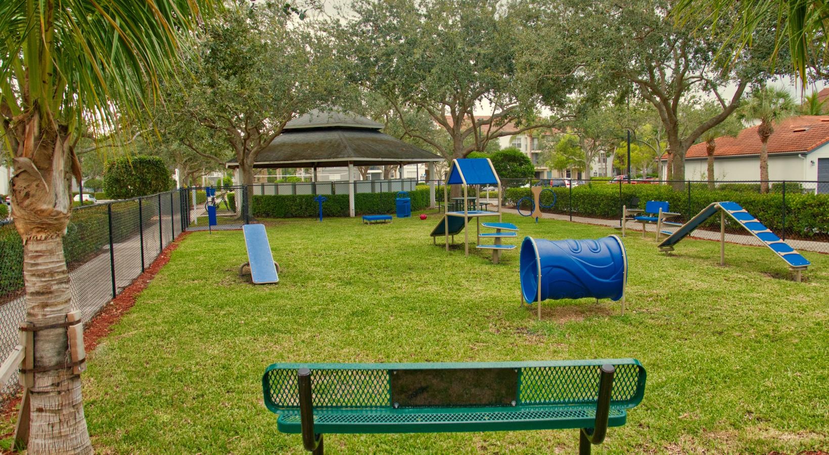 Find your perfect fit at The Sophia at Abacoa a dogpark with benches and trees