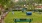 a dogpark with benches and trees