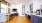 a large community kitchen with a wood floor