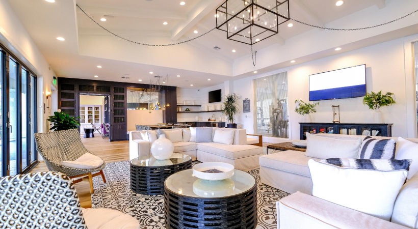 a clubhouse room with couches, chairs, and tables