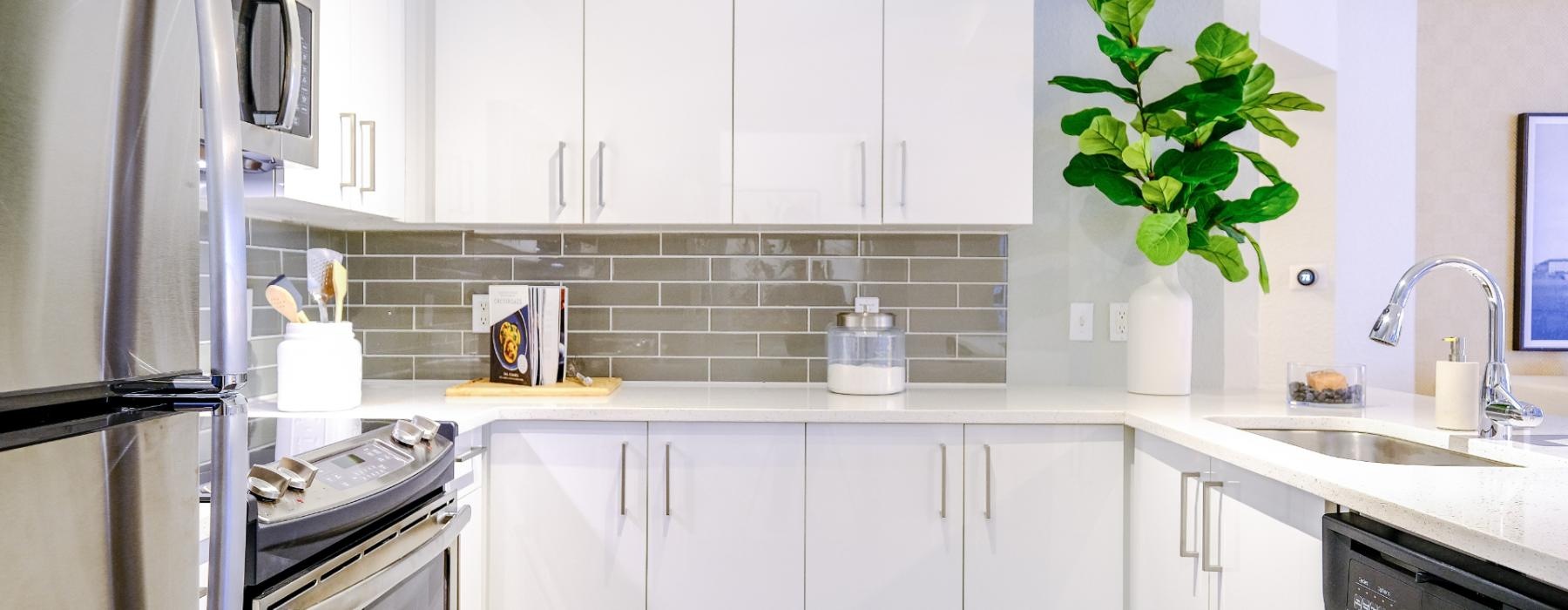 a kitchen with white cabinets