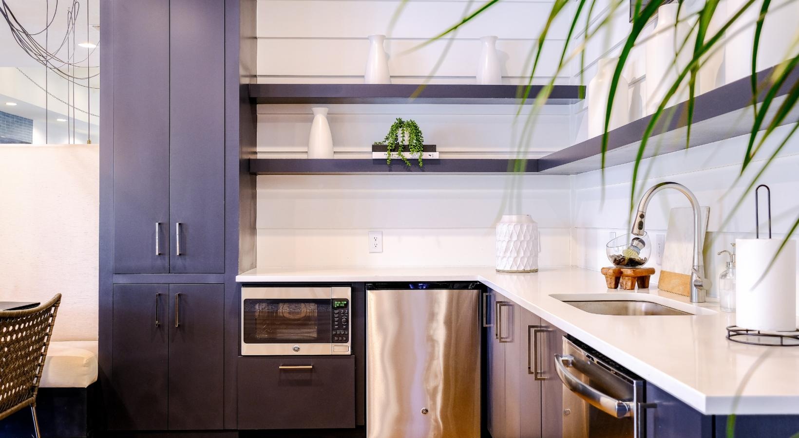Cutting-edge amenities at your fingertips a community kitchen with a plant on the wall
