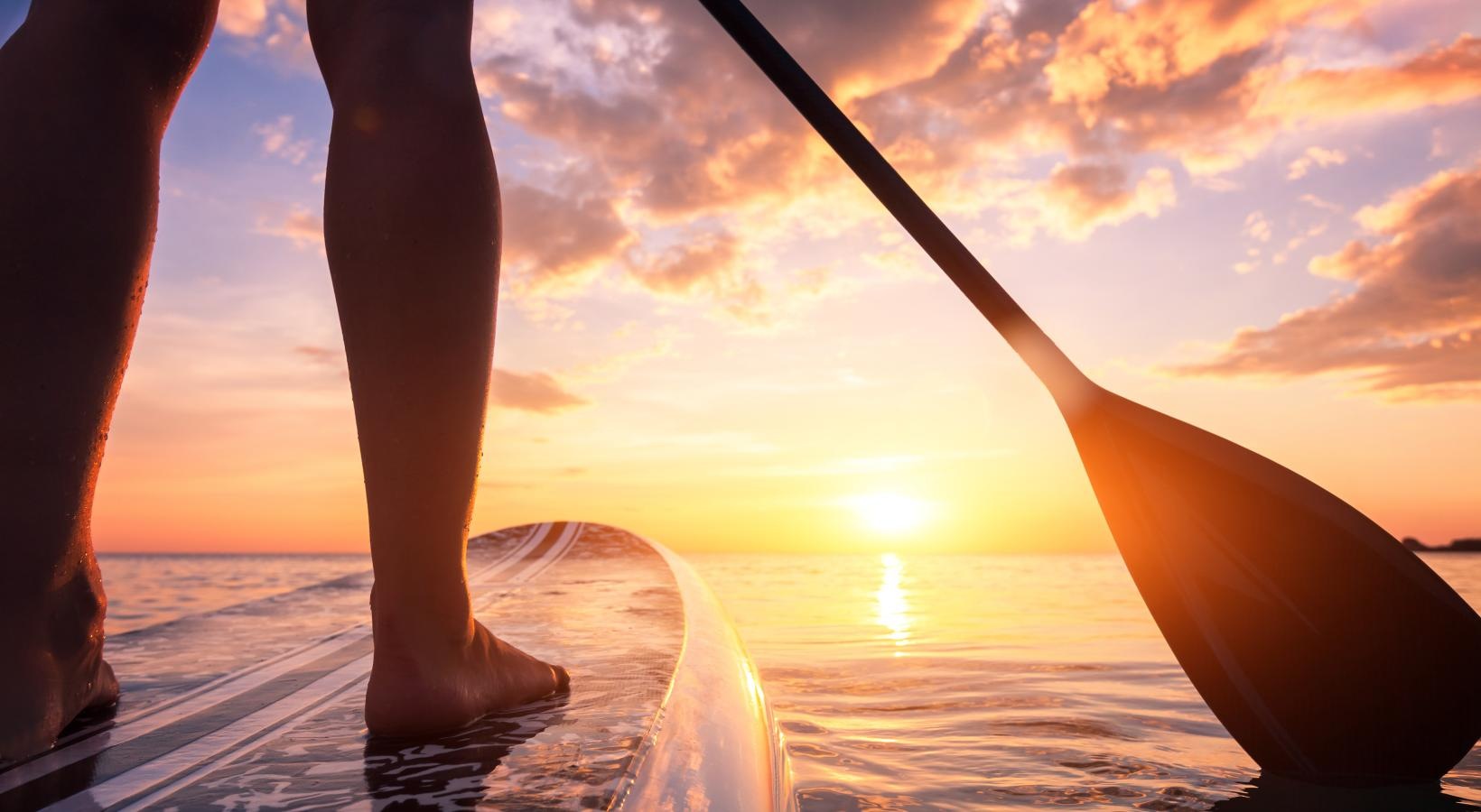 Settle into comfort at The Sophia at Abacoa a person paddle boarding in a body of water