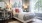 a bedroom with a bed and lamps