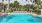 a pool with chairs and umbrellas by it