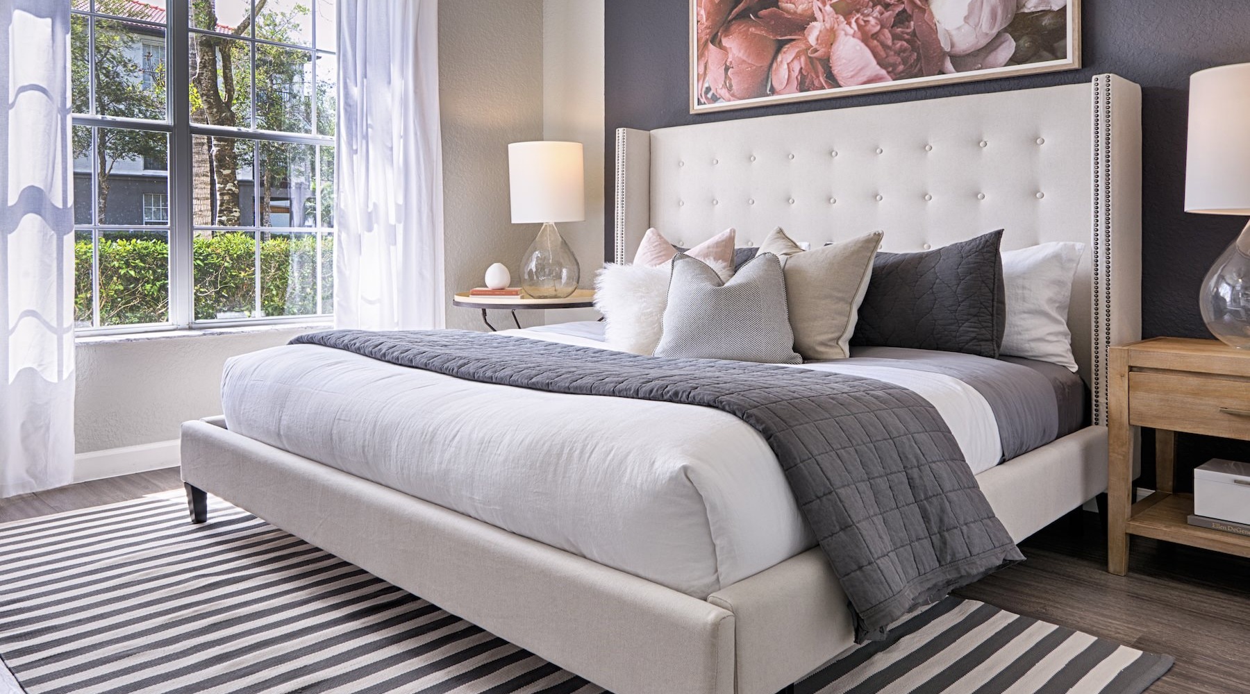 bedroom with large bed lamps and window