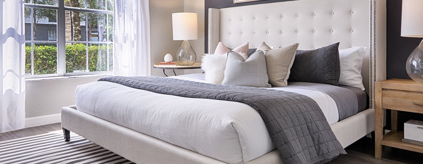 bedroom with large bed lamps and window