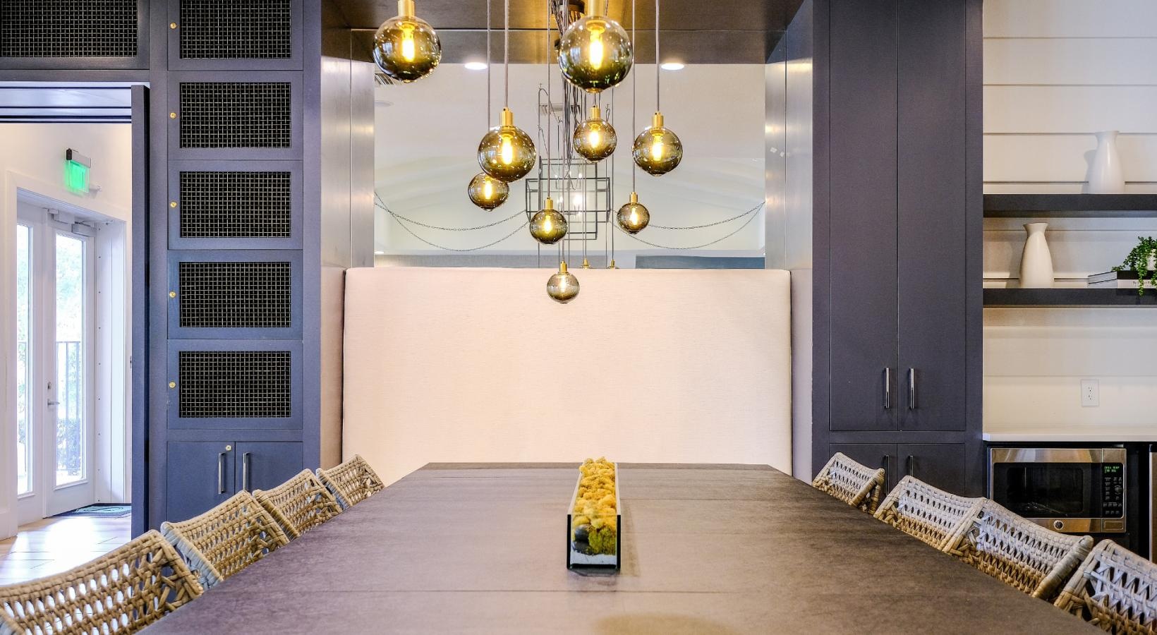 Quick access to state-of-the-art amenities a room with a table, chairs and a chandelier