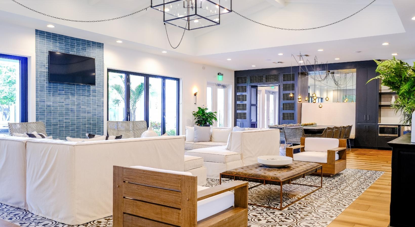 Settle into comfort at The Sophia at Abacoa a clubhouse lounge area with white couches and wood floors