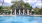 a pool with a gazebo and chairs by it