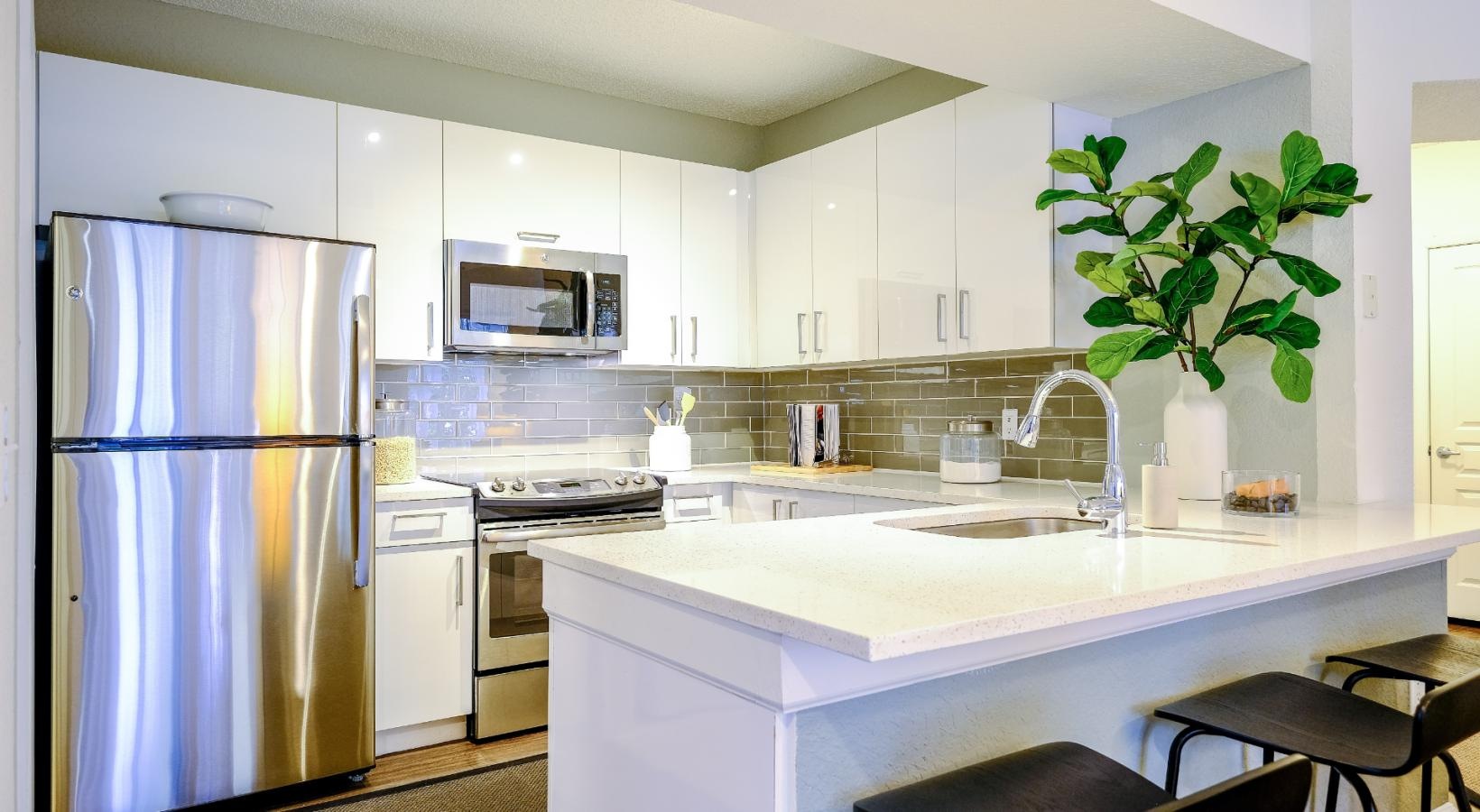 Spacious kitchens with thoughtful details a kitchen with white cabinets