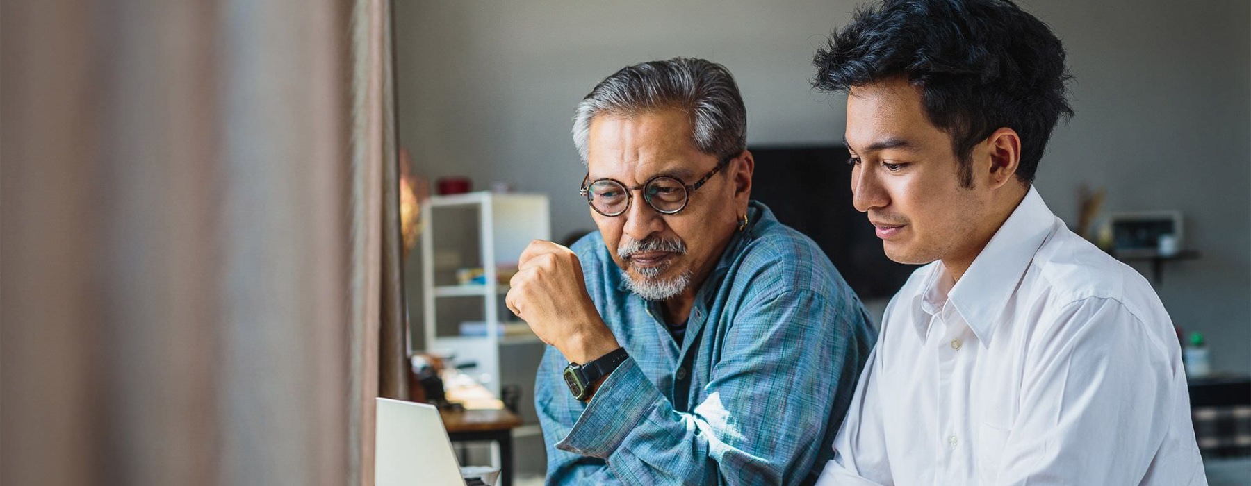two men working on a laptop