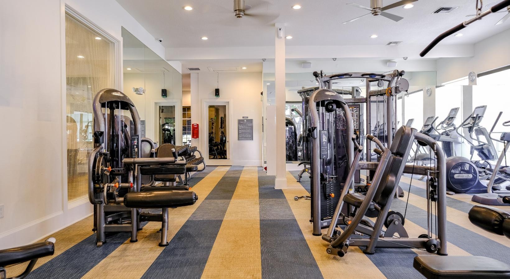 State-of-the-art amenities a gym with exercise equipment