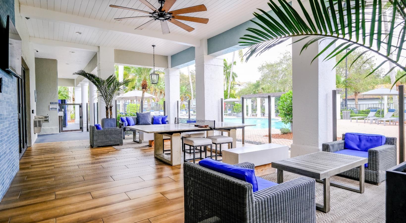 Cutting-edge amenities at your fingertips a community patio area with a table chairs and a fan