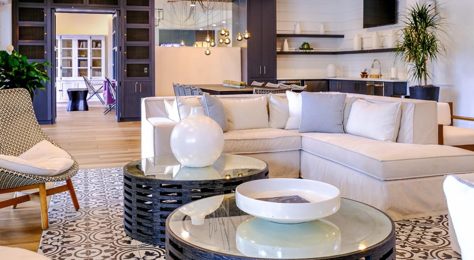 Cutting-edge amenities at your fingertips a clubhouse room with couches, chairs, and tables