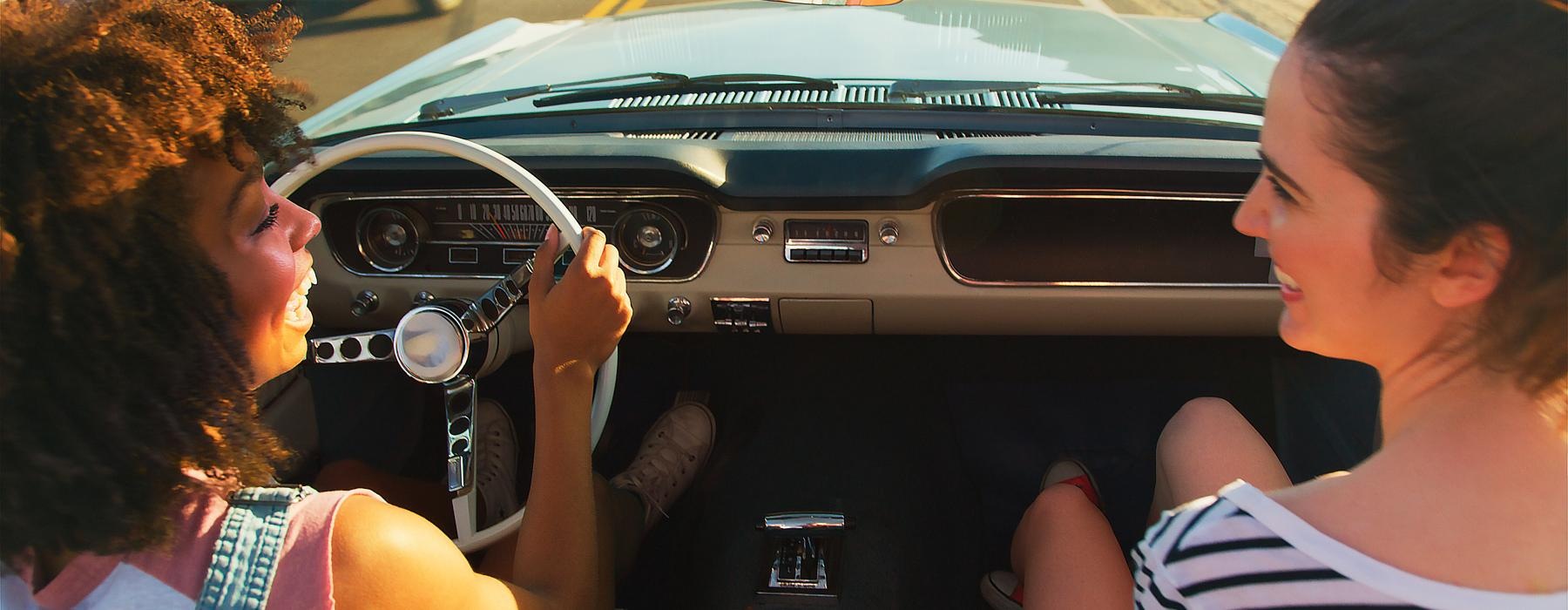 people driving a car and smiling