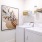 a white laundry room with a picture on the wall