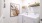 a white laundry room with a picture on the wall