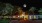 a building with palm trees and a moon in the sky
